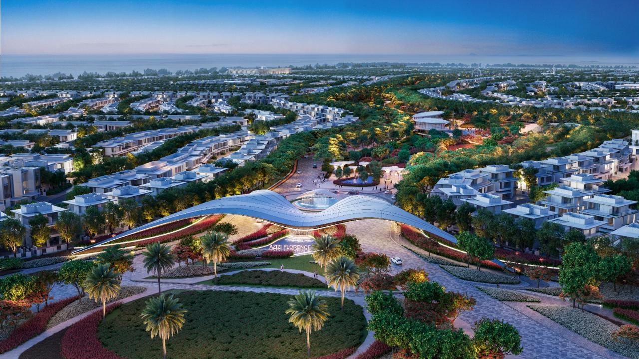 Azizi Florence Sharjah — the community gateway, central park and surrounding villa clusters at dusk